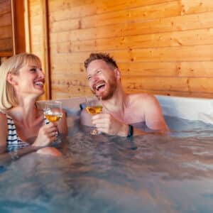 Couple relaxing and drinking wine in a hot tub